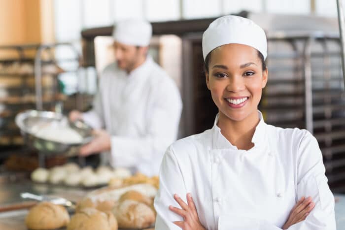 Pretty,Baker,Smiling,At,Camera,In,The,Kitchen,Of,The Pretty,Baker,Smiling,At,Camera,In,The,Kitchen,Of,The
